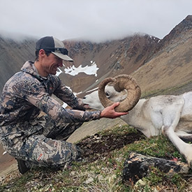 Hunter holding a Stone's sheep